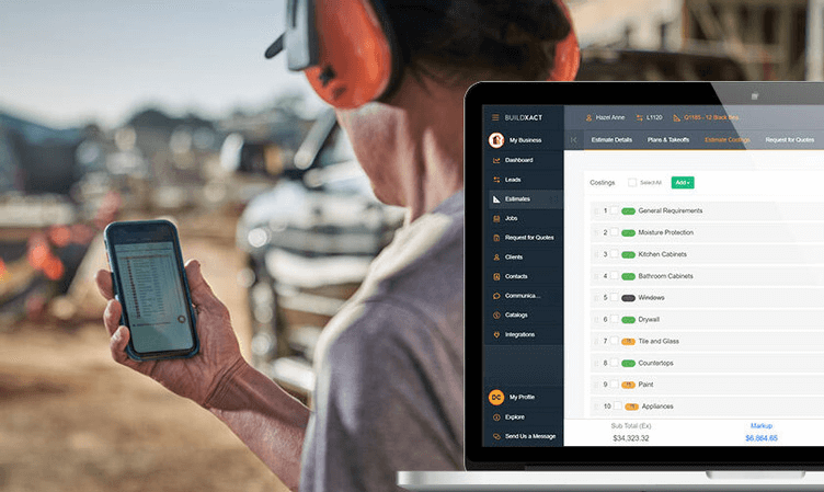Contractor reviewing a preliminary construction estimate on a mobile phone while cost breakdowns are displayed in estimating software on a laptop at a job site.