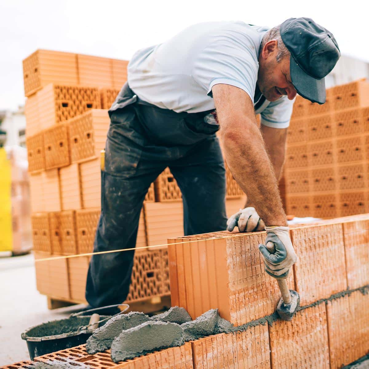 A bricklayer working on a construction site.