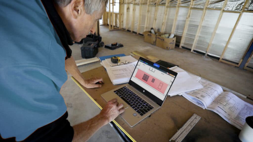 Man working on plans during a residential build.