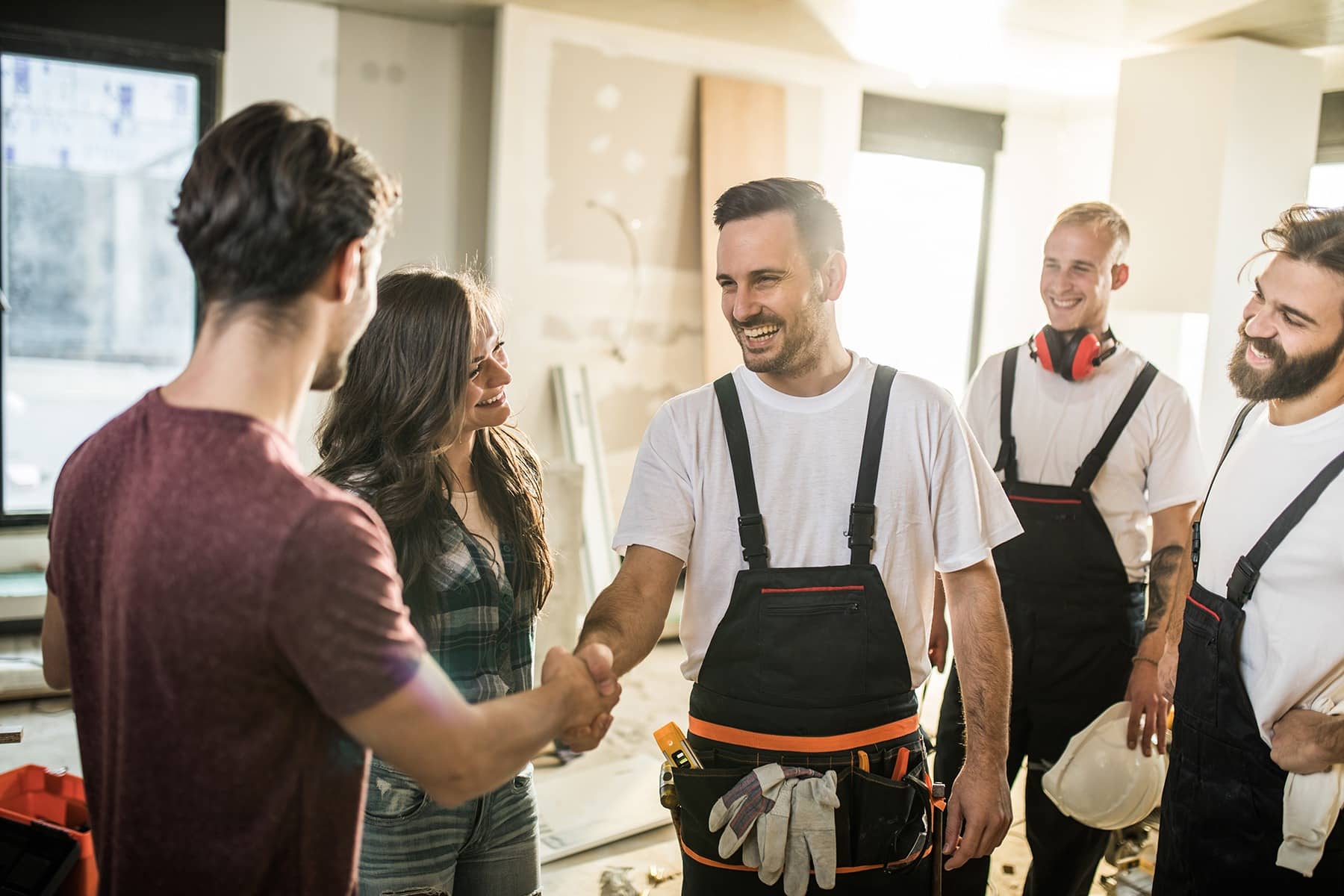 Builders meeting clients on a construction site