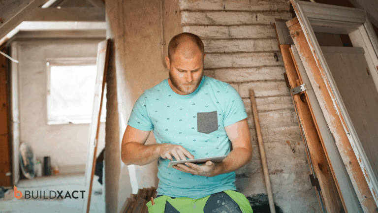 Residential builder reviewing a construction bid and cost estimate on a tablet at an active job site