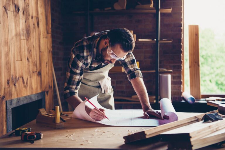 A builder looking at plans, working manually