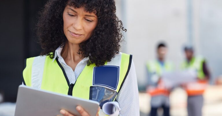Female builder looking at a tablet on a construction site