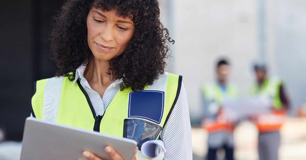 Female builder looking at a tablet on a construction site