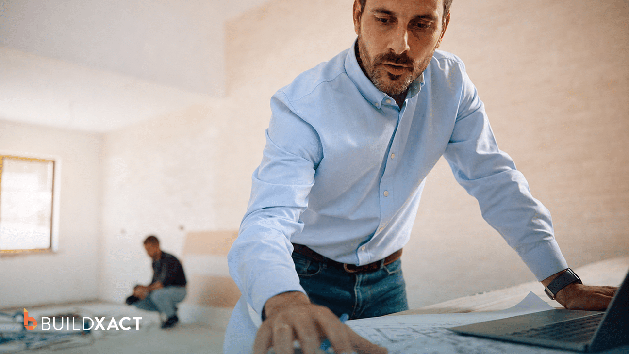 Residential builder reviewing digital plans and an estimate on a laptop