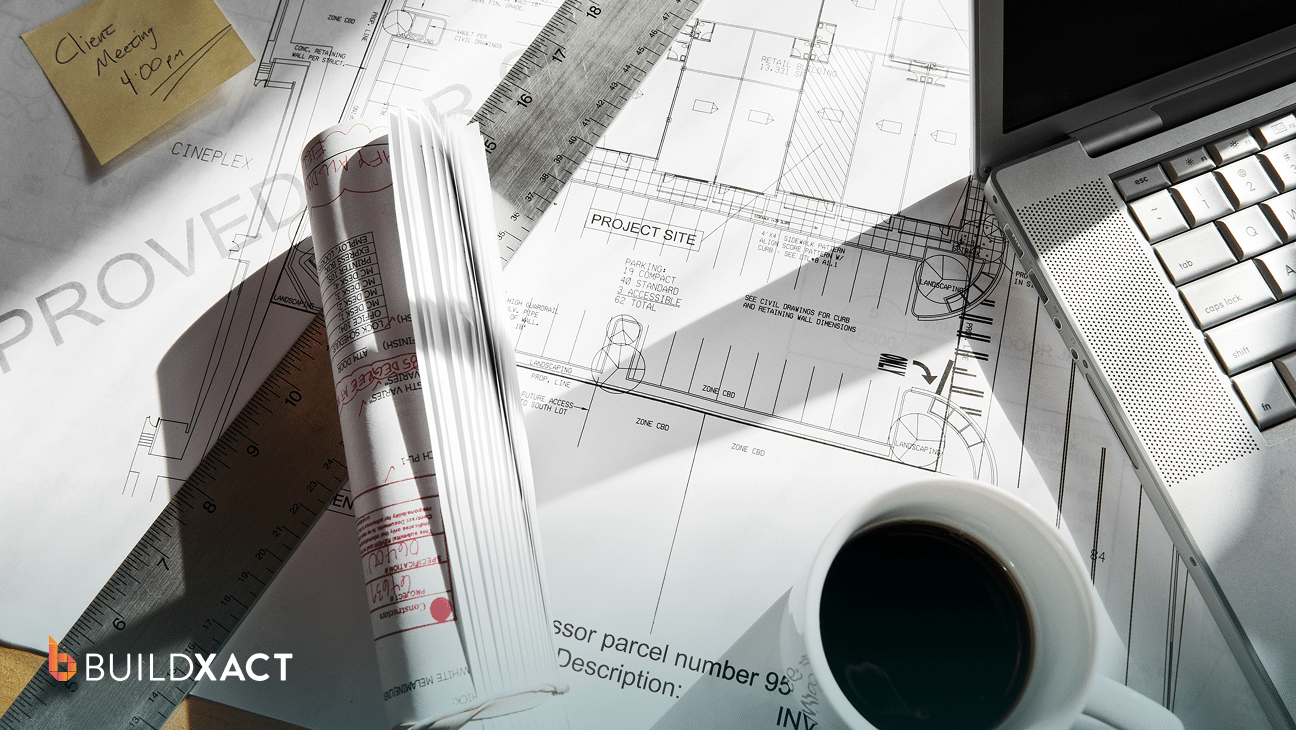 Residential estimating workspace with house plans and a laptop showing estimate line items in the evening